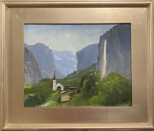 Painting of Lauterbrunnen Valley by Henry Leck, featuring a church and waterfall nestled between towering mountains, framed in silver.