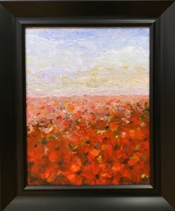 Painting of vibrant poppy fields beneath a sky filled with clouds by Henry Leck, framed in black.