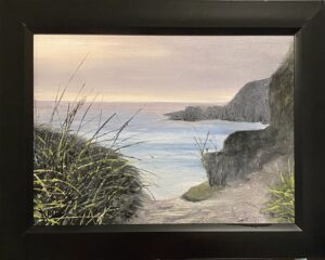 Painting of a rocky shore at sunset by Henry Leck, featuring grassy cliffs and calm ocean waters, framed in black.