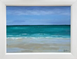 Painting of a calm beach with soft waves and clear blue skies by Henry Leck, framed in white.