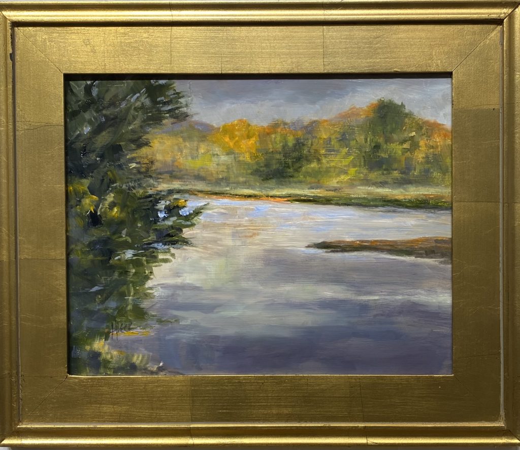 Framed oil painting titled 'Sheltered Water' by Henry Leck, depicting a calm river reflecting the autumn foliage of distant trees under a soft sky.