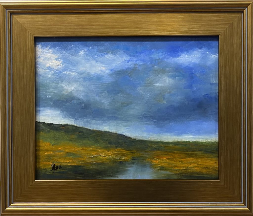 Framed oil painting titled 'Storm Brewing' by Henry Leck, featuring a vast open landscape under a dramatic sky with dark storm clouds rolling in.